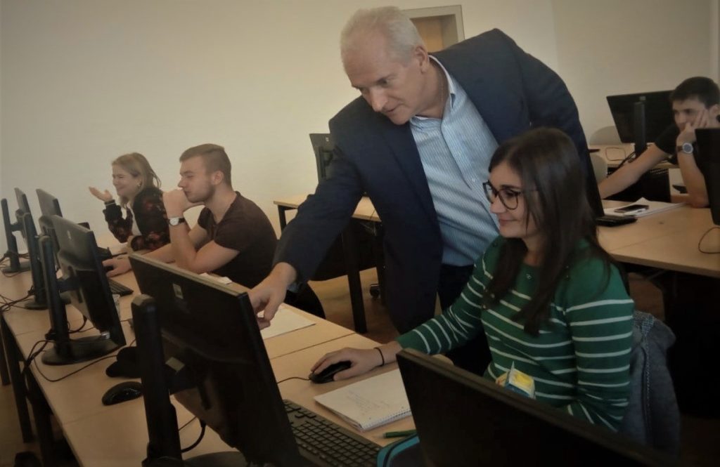 Dr Tim Young working with students in the lab