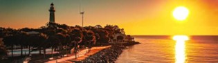 Sunrise over ocean with hosting facilities in foreground