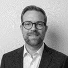 Headshot of man in glasses and suit